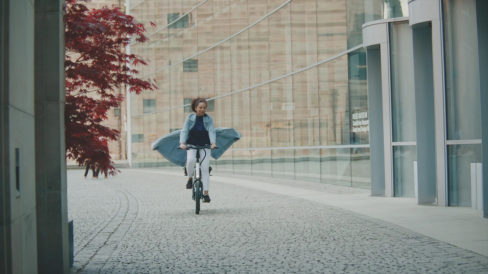 Nanno Bike with Women riding in urban setting with cargo rack